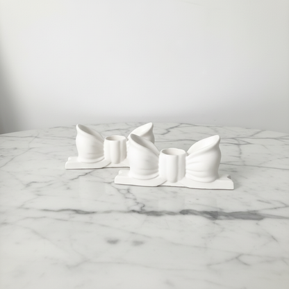 Bow candle holders on marble