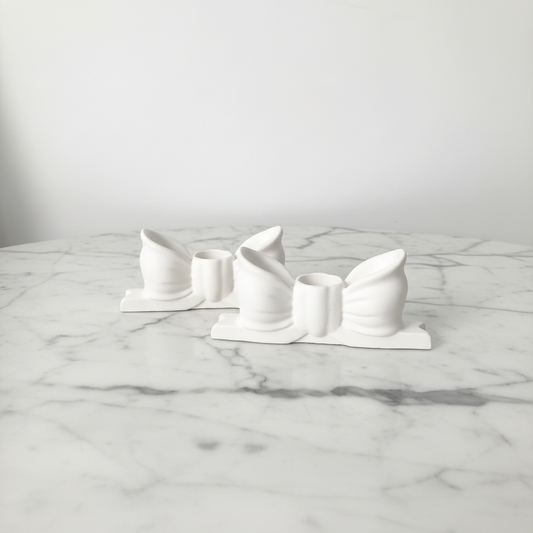 Bow candle holders on marble